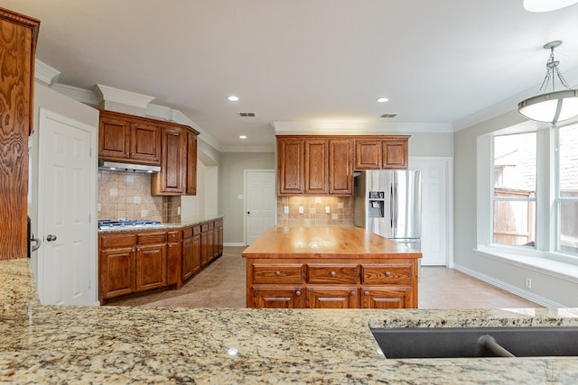 kitchen with backsplash, pendant lighting, appliances with stainless steel finishes, and light tile floors