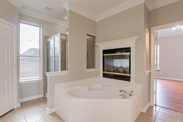 bathroom with a multi sided fireplace, ornamental molding, separate shower and tub, and tile flooring