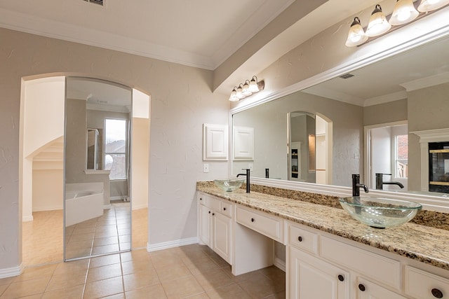 bathroom with double sink, tile floors, a bath, vanity with extensive cabinet space, and crown molding