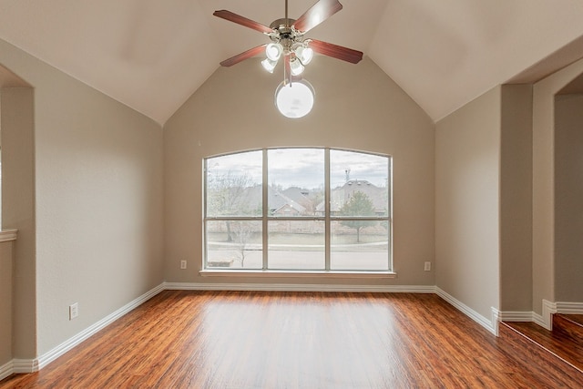 unfurnished room with ceiling fan, dark wood-type flooring, vaulted ceiling, and plenty of natural light