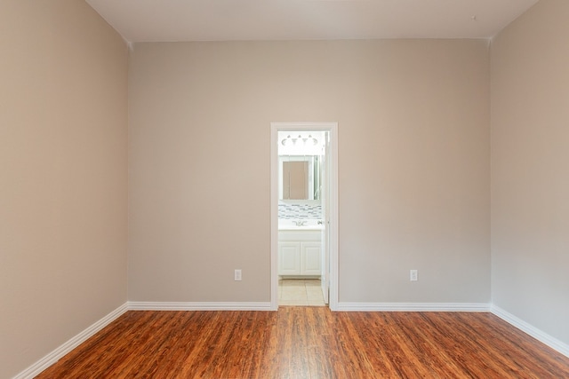 spare room with dark hardwood / wood-style flooring