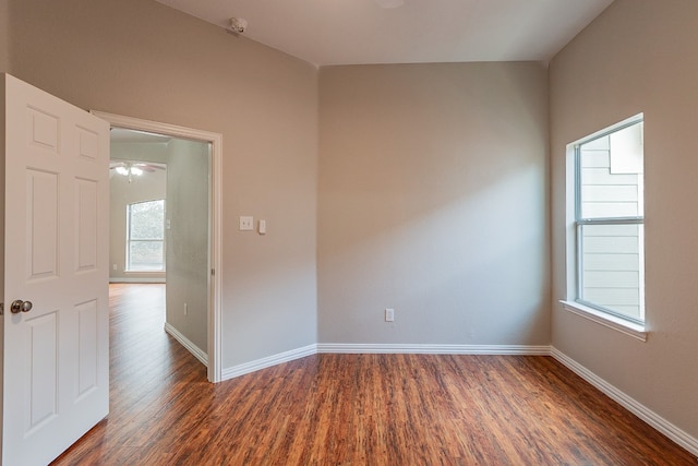 spare room with ceiling fan and dark hardwood / wood-style floors