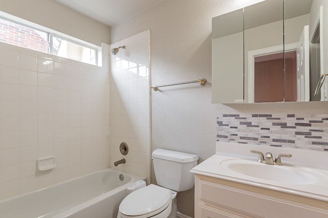 full bathroom featuring backsplash, large vanity, toilet, and tiled shower / bath