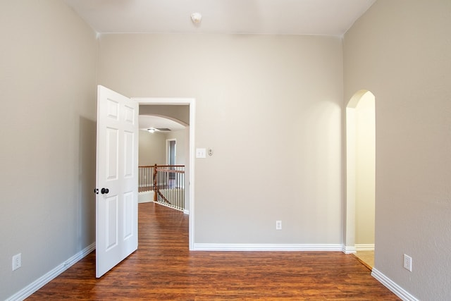 spare room with ceiling fan and dark wood-type flooring