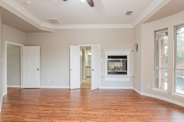 unfurnished living room with ceiling fan, crown molding, and wood-type flooring