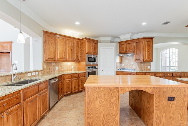 kitchen featuring wood counters, a kitchen island, tasteful backsplash, and stainless steel appliances