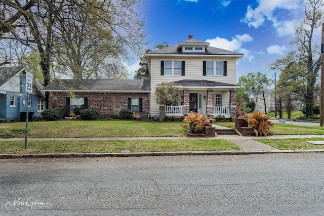 view of front of property with a front yard and a porch