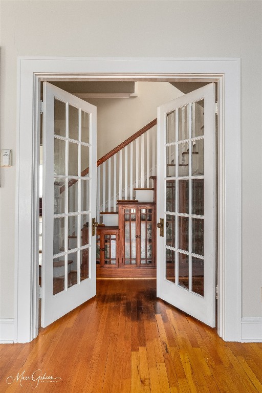 entryway with hardwood / wood-style floors and french doors