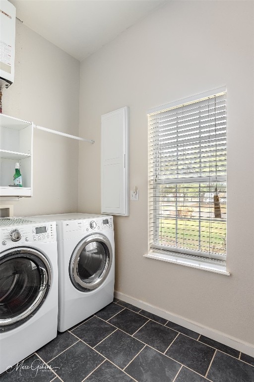 washroom featuring hookup for a washing machine, washing machine and dryer, and dark tile flooring