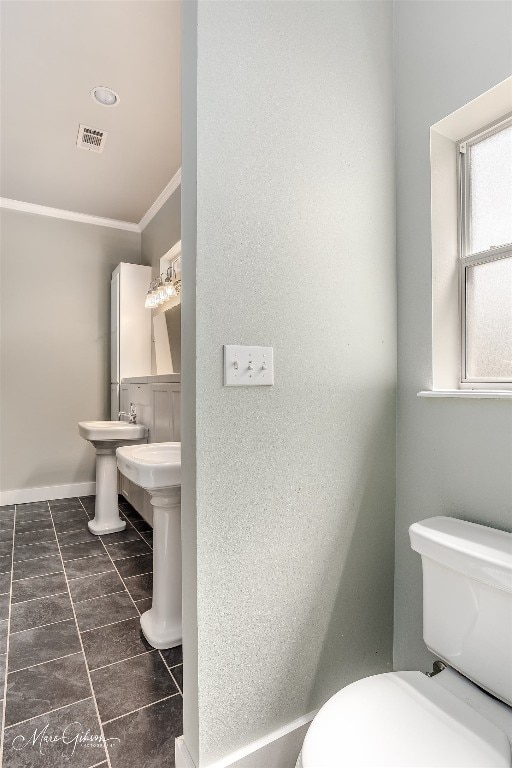 bathroom with ornamental molding, tile flooring, and toilet