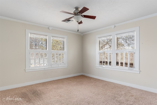 empty room with ceiling fan, light colored carpet, and plenty of natural light