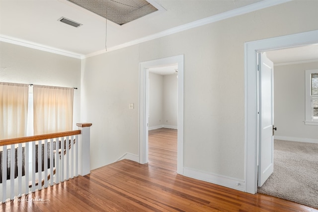 hall with light carpet and crown molding