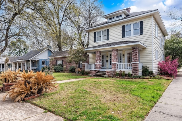 view of front of house with covered porch and a front yard