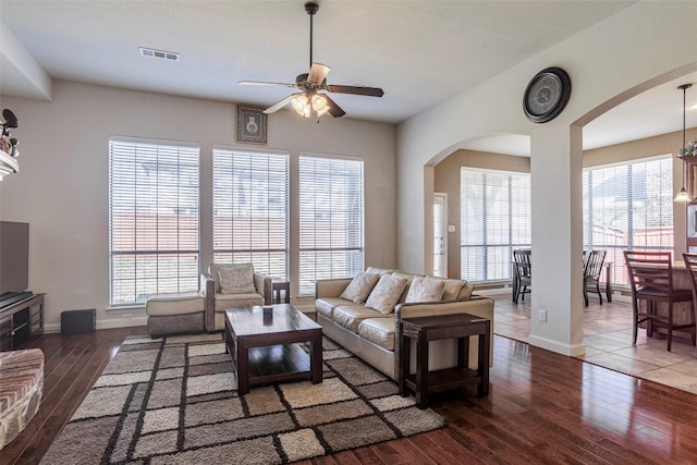 living room featuring dark tile floors and ceiling fan