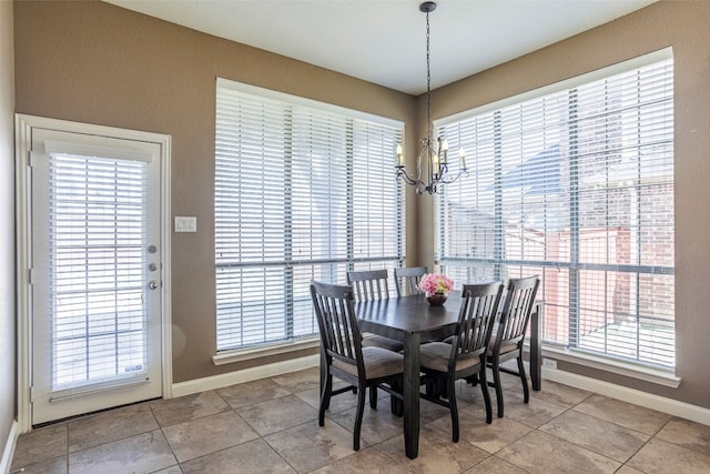 dining space with a notable chandelier and light tile floors