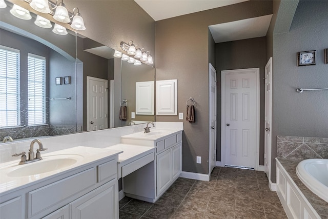 bathroom with double sink, tile flooring, oversized vanity, and a tub