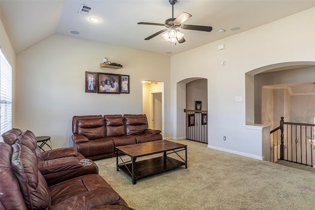 carpeted living room featuring ceiling fan and vaulted ceiling