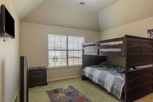 bedroom featuring multiple windows, vaulted ceiling, and light colored carpet