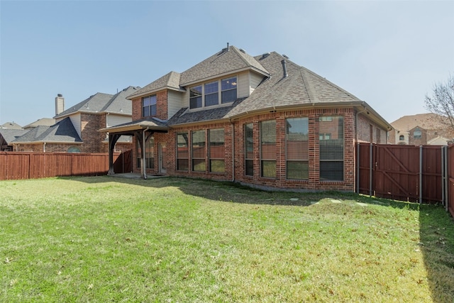 rear view of house with a lawn