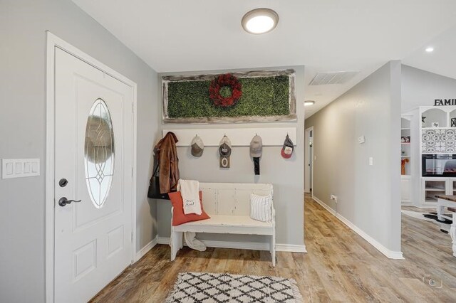 entryway featuring hardwood / wood-style floors and lofted ceiling