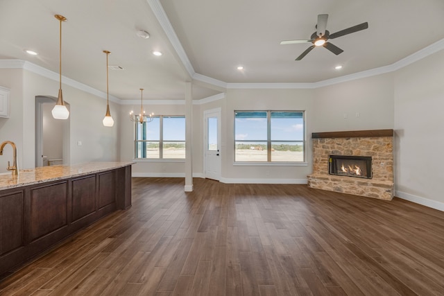 spare room featuring a wealth of natural light, ceiling fan, and dark hardwood / wood-style floors