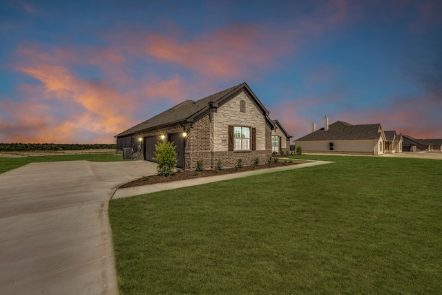 view of front of home featuring a garage and a lawn