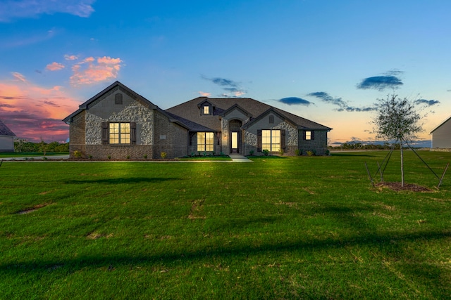 french country style house featuring a lawn