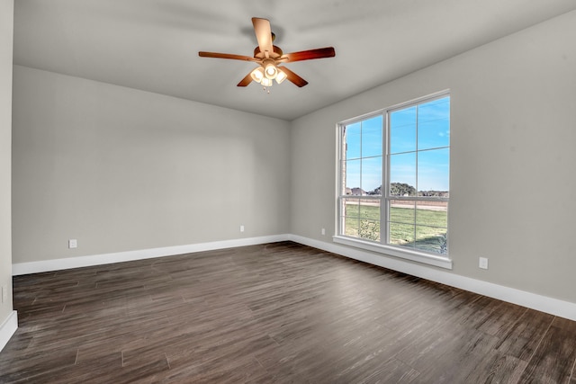 spare room with ceiling fan and dark hardwood / wood-style floors