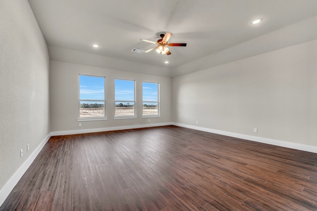 spare room with dark hardwood / wood-style flooring and ceiling fan