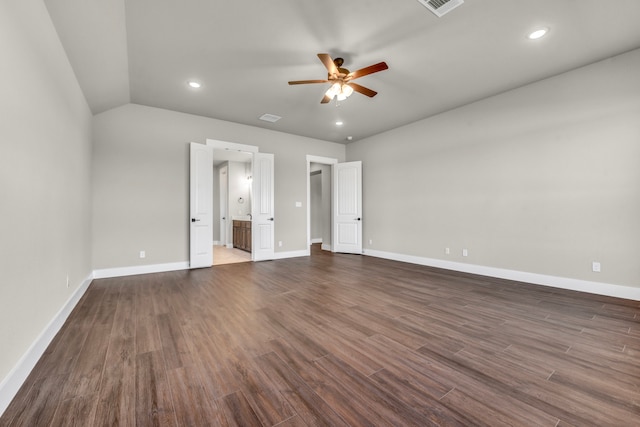 unfurnished bedroom featuring lofted ceiling, ceiling fan, dark hardwood / wood-style floors, and connected bathroom