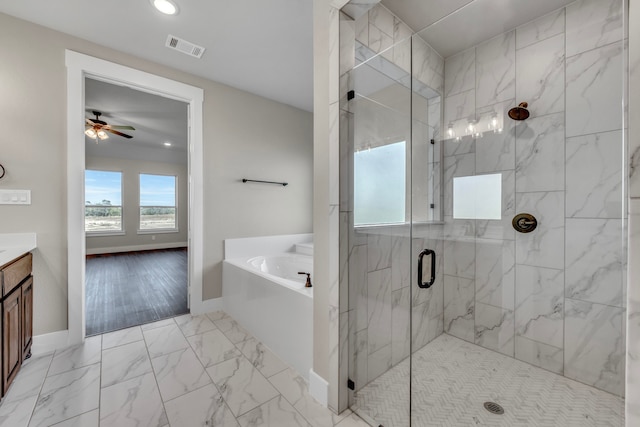 bathroom featuring ceiling fan, independent shower and bath, wood-type flooring, and vanity