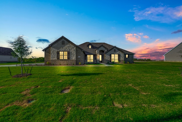 french provincial home with a yard