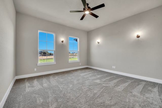 carpeted spare room featuring ceiling fan