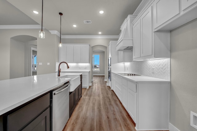 kitchen featuring white cabinetry, decorative light fixtures, and dishwasher