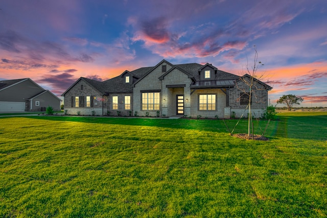 french country style house featuring a yard