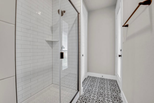 bathroom with a wealth of natural light, tile patterned floors, and an enclosed shower