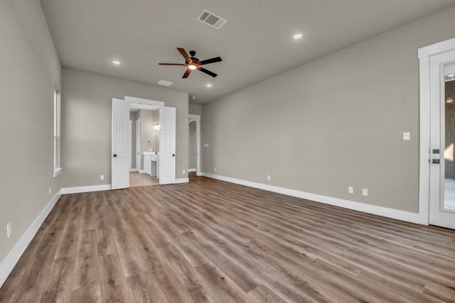 unfurnished bedroom with ensuite bathroom, light hardwood / wood-style flooring, and ceiling fan