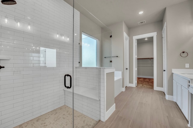 bathroom with vanity and plus walk in shower