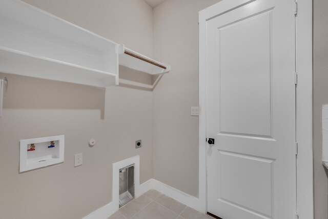 clothes washing area featuring hookup for an electric dryer, hookup for a washing machine, light tile patterned floors, and gas dryer hookup