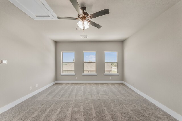 empty room featuring ceiling fan and light colored carpet