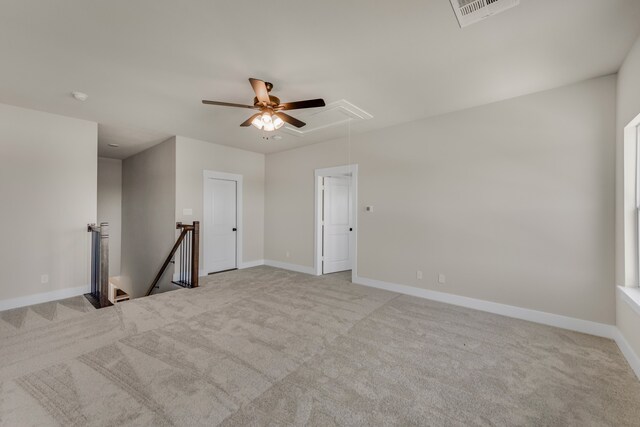 carpeted spare room featuring ceiling fan