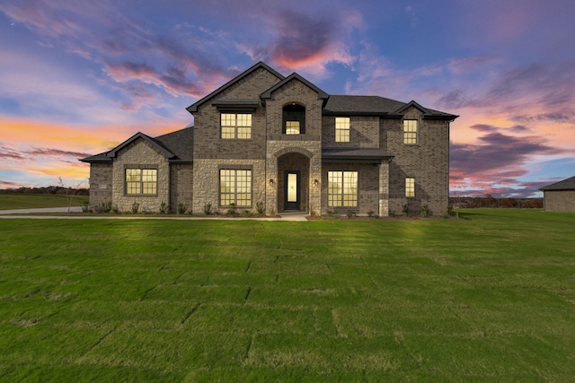 french provincial home featuring a front yard