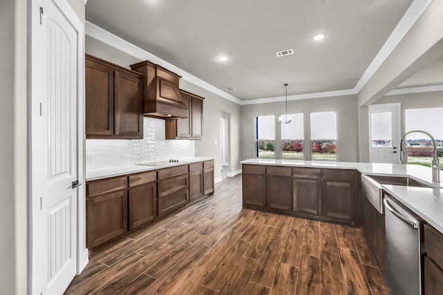 kitchen with ornamental molding, dark brown cabinetry, dark wood-type flooring, and a notable chandelier