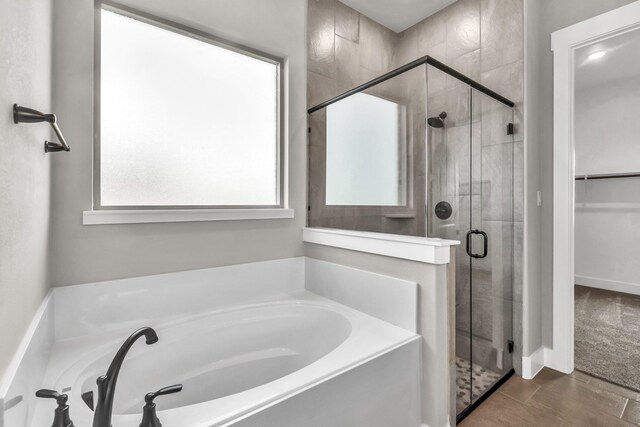 bathroom with tile patterned floors and shower with separate bathtub