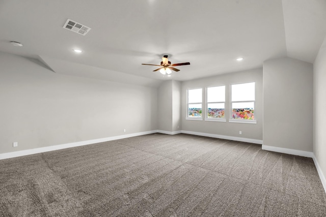 empty room featuring ceiling fan, carpet, and vaulted ceiling