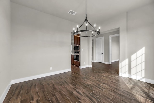 kitchen with custom range hood, a center island with sink, crown molding, and dark wood-type flooring