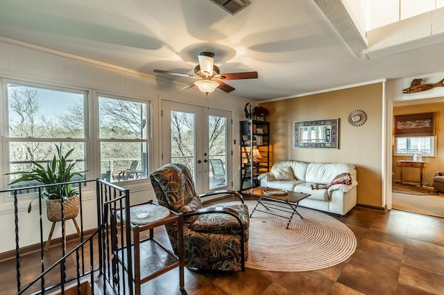 living room featuring visible vents, baseboards, ceiling fan, ornamental molding, and french doors