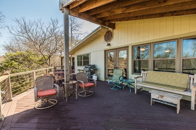 deck with french doors and area for grilling