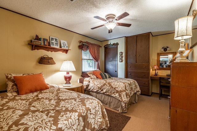 bedroom with a textured ceiling, ceiling fan, crown molding, and light colored carpet