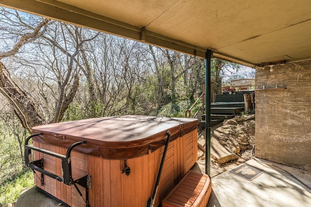 wooden deck featuring a hot tub